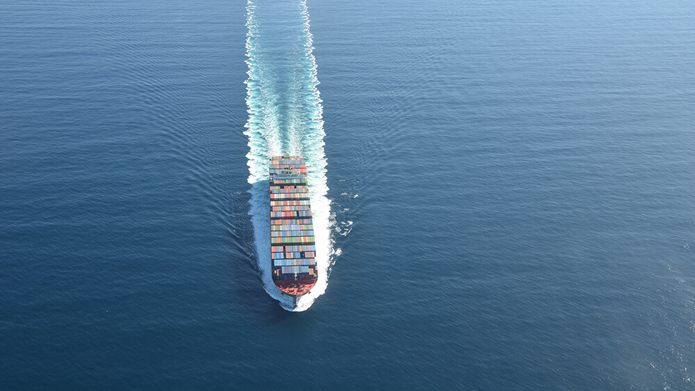 aerial view of a container ship in open water